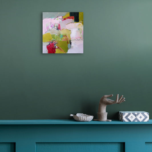Of Morning And Mist by Karen Hammat displayed on a deep green wall above a teal mantel in a contemporary interior.