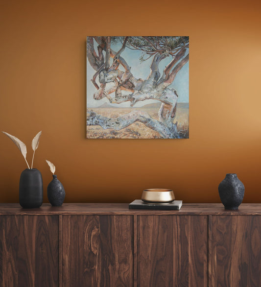Shepherd Tree Tango by Hein Botha, South African landscape painting displayed against a warm ochre wall above a dark wooden sideboard.