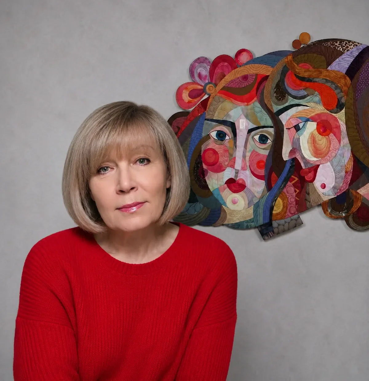Artist Galla Grotto with a colourful figurative textile artwork featuring layered faces in the background.