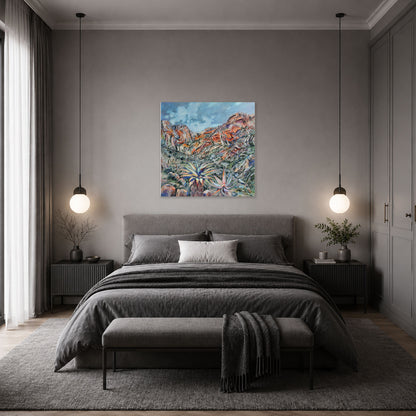 A modern bedroom with a gray upholstered bed, matching bench, pendant lights, and a colorful abstract landscape painting by Hein Botha centered on the gray wall above the bed.