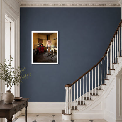 A framed art photography print depicting a vintage kitchen scene with a red range displayed on a dark blue wall in a Georgian hallway with a staircase and console tablee.