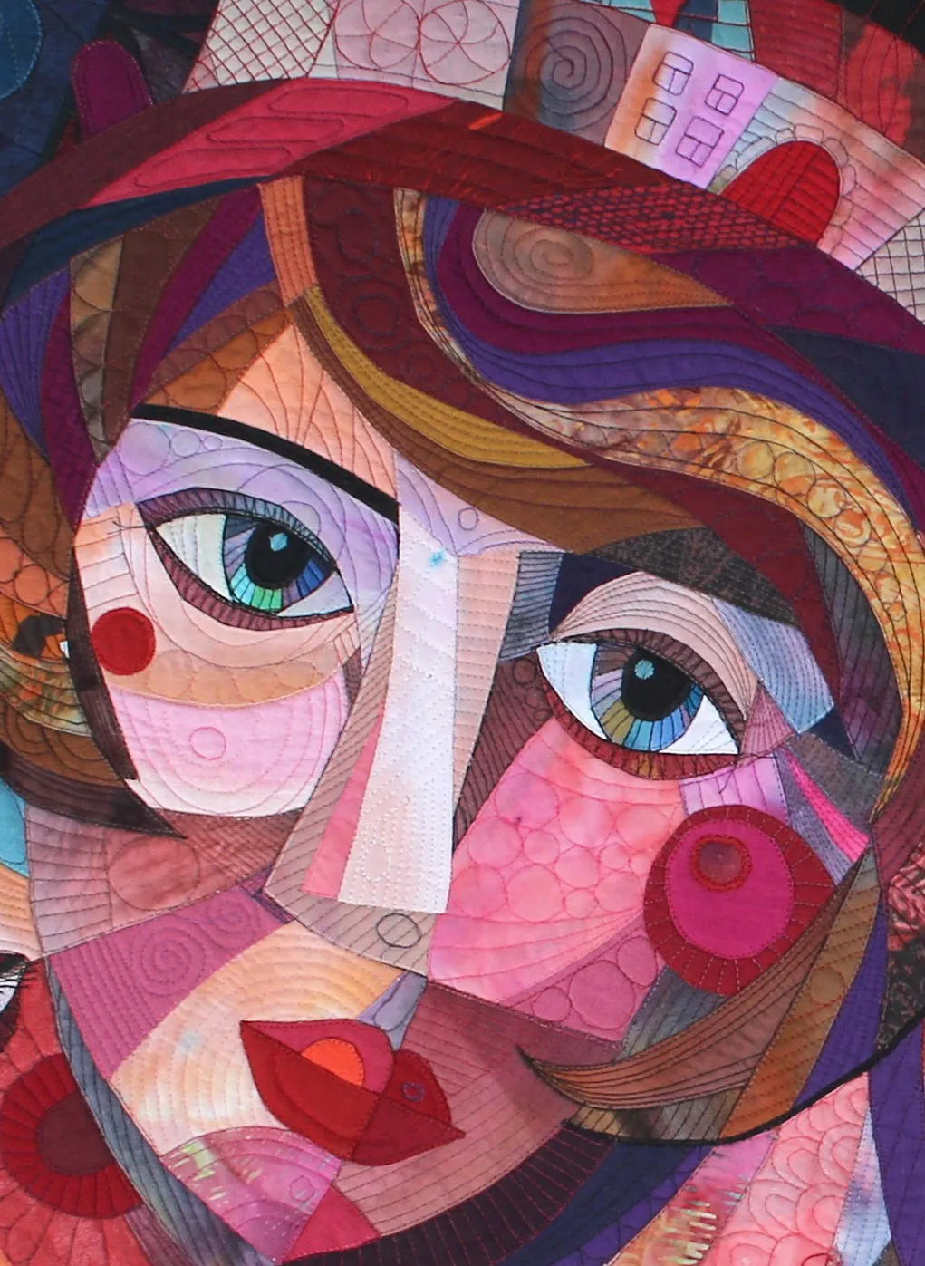 Detail of Galla Grotto’s Equilibrium (Territory of Women), showing a woman’s face constructed from colourful layered fabrics and intricate stitching.