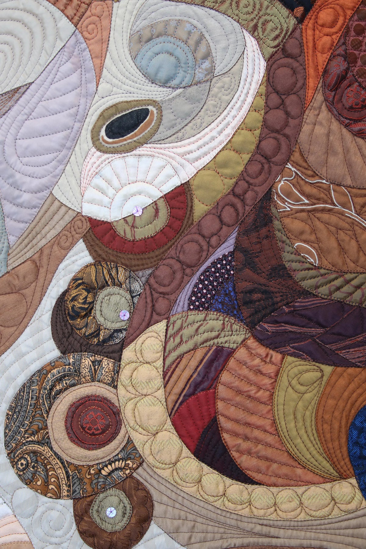 Detail of Evening Star by woman textile artist Galla Grotto, showing layered fabric, intricate stitching and abstract organic forms.