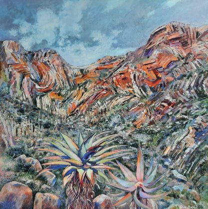 An expressive landscape painting of a desert mountain scene in South Africa with orange and brown rock formations, blue sky, and colorful succulents in the foreground.
