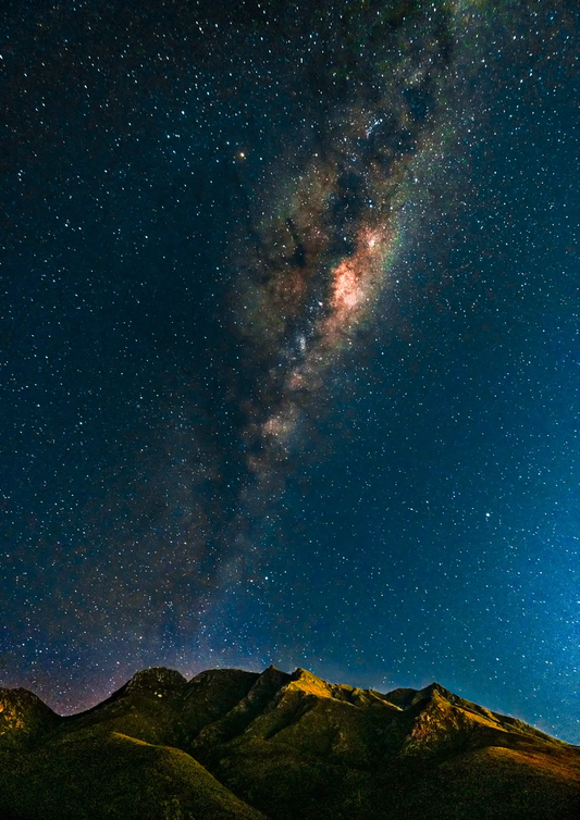 Milky Way Over the Outeniquas by Chris Daly, astrophotography landscape of a star-filled night sky and Milky Way above the Outeniqua Mountains, South Africa.