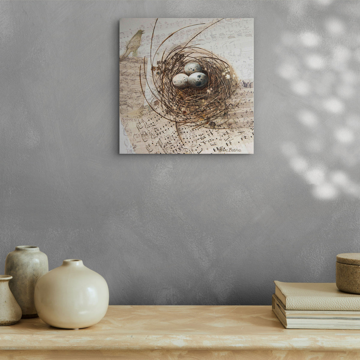 Hein Botha nest art print displayed above a wooden shelf in a neutral interior
