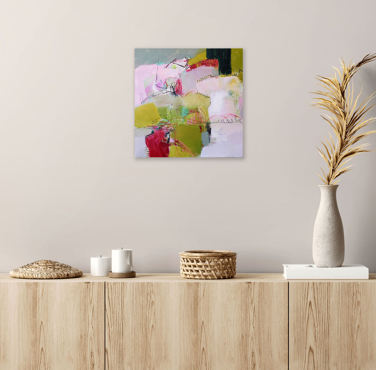 Of Morning And Mist by Karen Hammat displayed on a pale neutral wall above a light wood sideboard with ceramics and dried foliage.