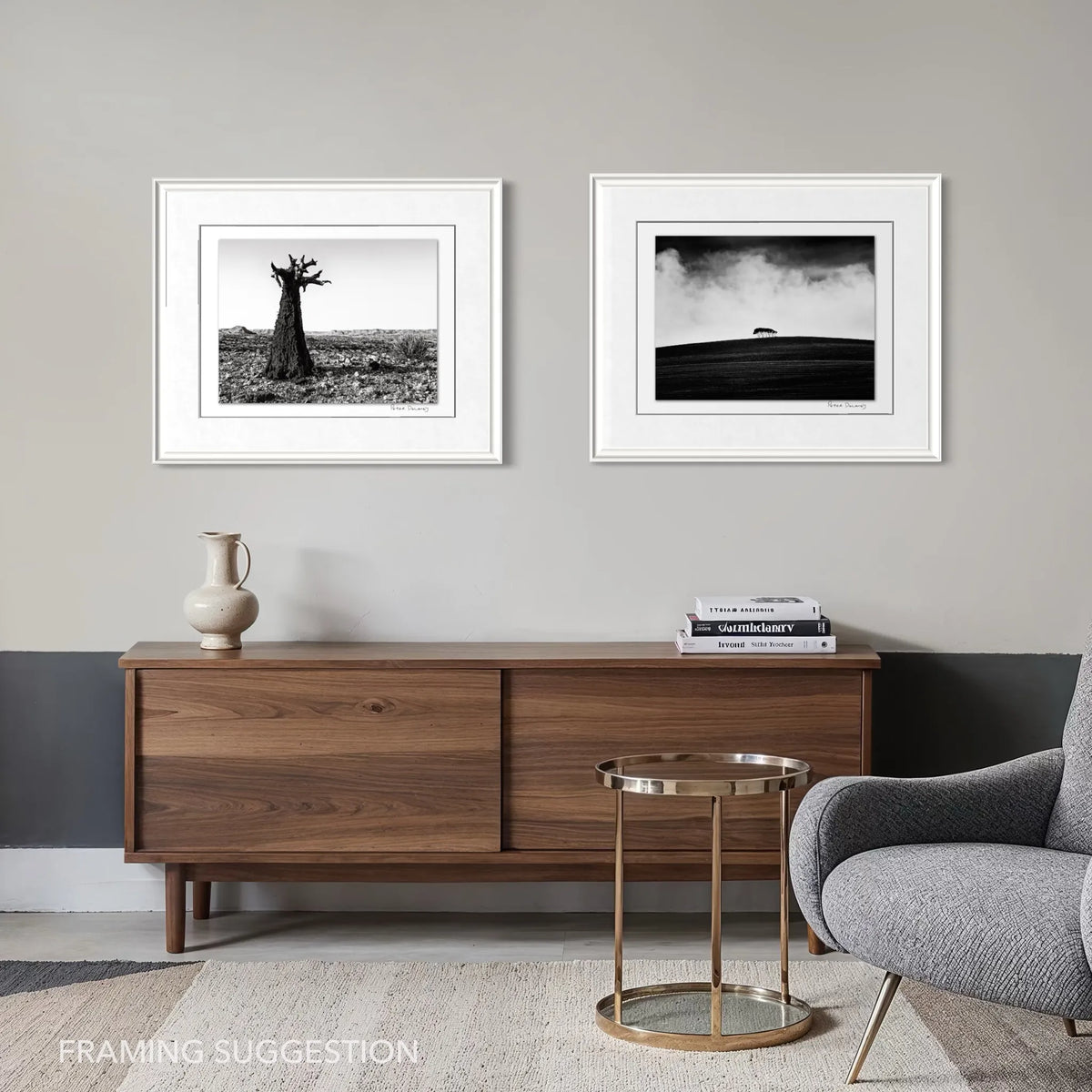 Peter Delaney black and white landscape photography set, featuring a quiver tree and moody landscape, displayed in white frames above a wooden sideboard.