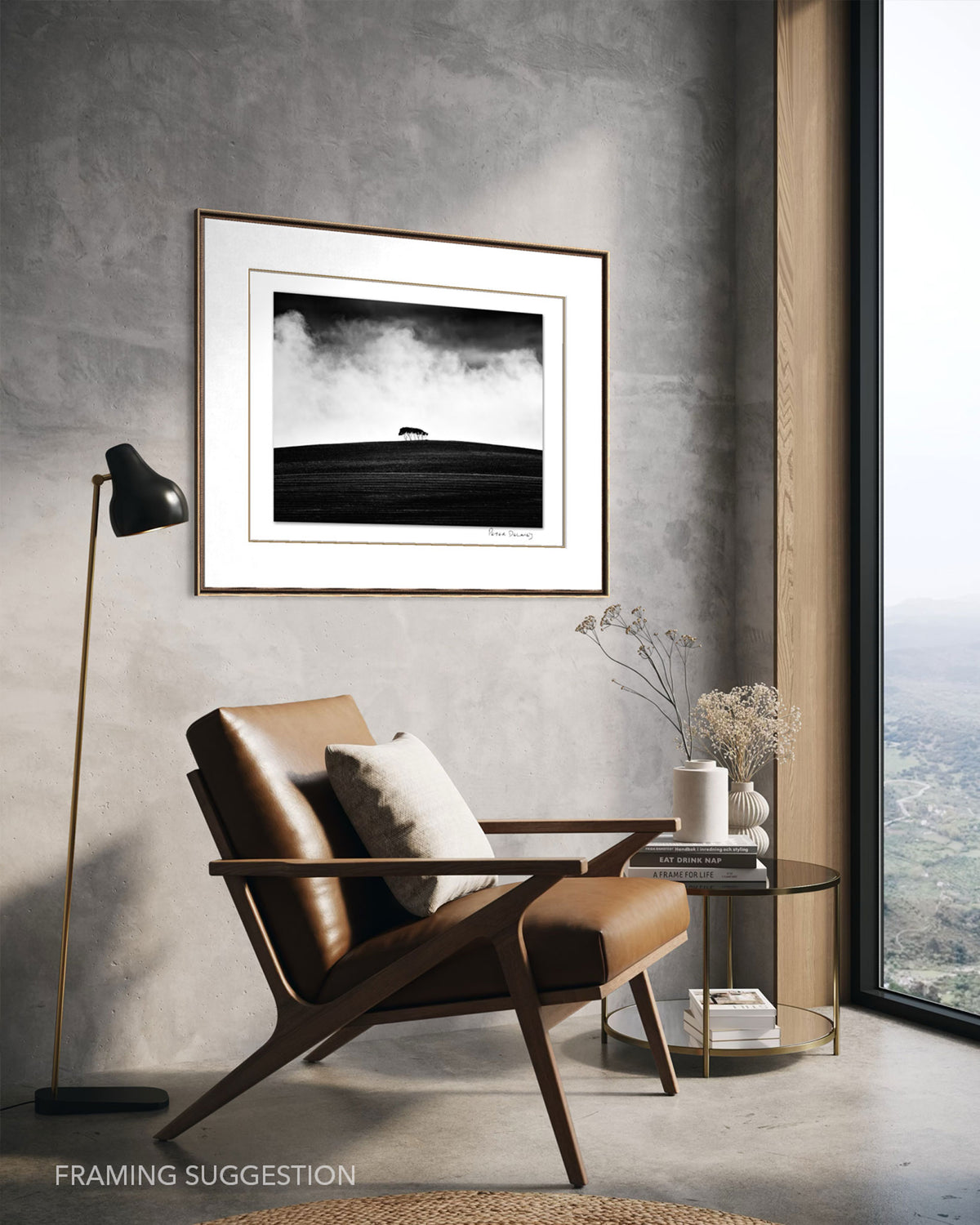 Peter Delaney’s Kareno: The Withered Field framed in a contemporary interior above a leather armchair, showing a suggested presentation for the black and white photograph.