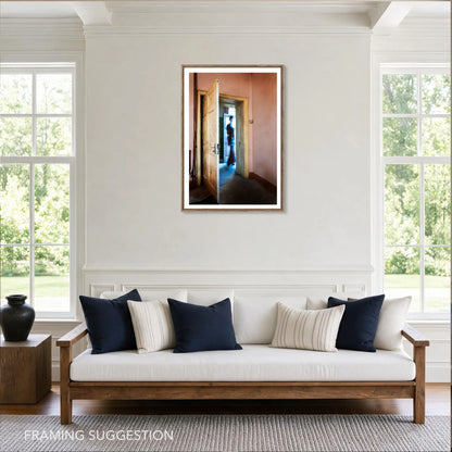 The Crossing by Robyn Daly, large photographic print shown framed with a white border above a sofa in a bright interior.