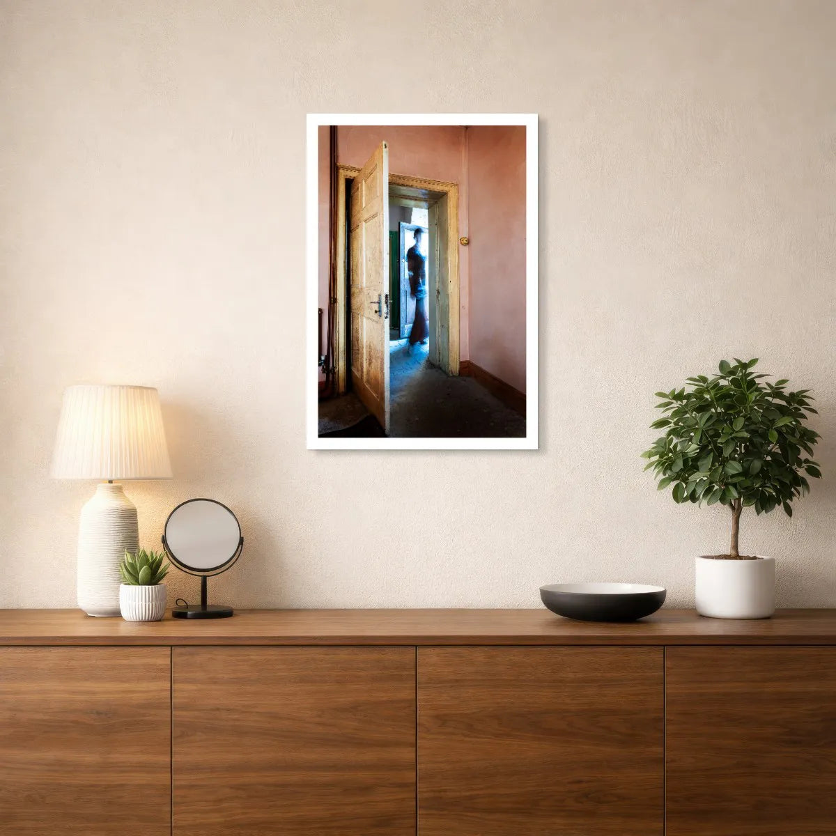 The Crossing by Robyn Daly, medium-size photographic print with a white border, displayed above a wooden sideboard.