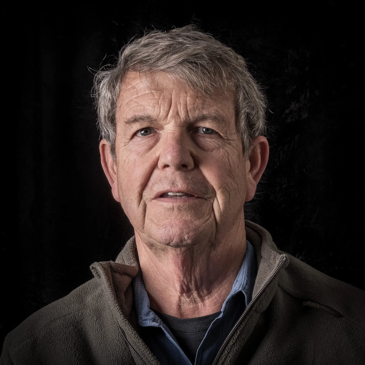Portrait of South African landscape photographer Chris Daly against a dark background.