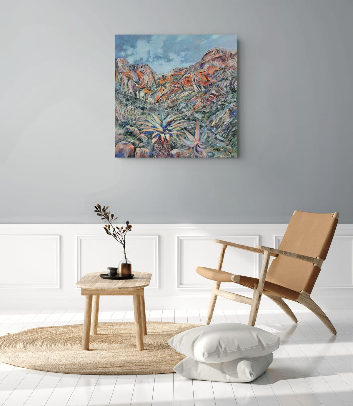 Meiringspoort by Hein Botha, an expressive South African landscape painting of the dramatic rocky mountains and vegetation of Meiringspoort, shown in a contemporary interior.