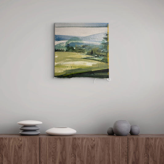 An abstract landscape painting in muted green, blue, and gray tones, displayed on a light gray wall above a wooden sideboard with decorative ceramic vases.